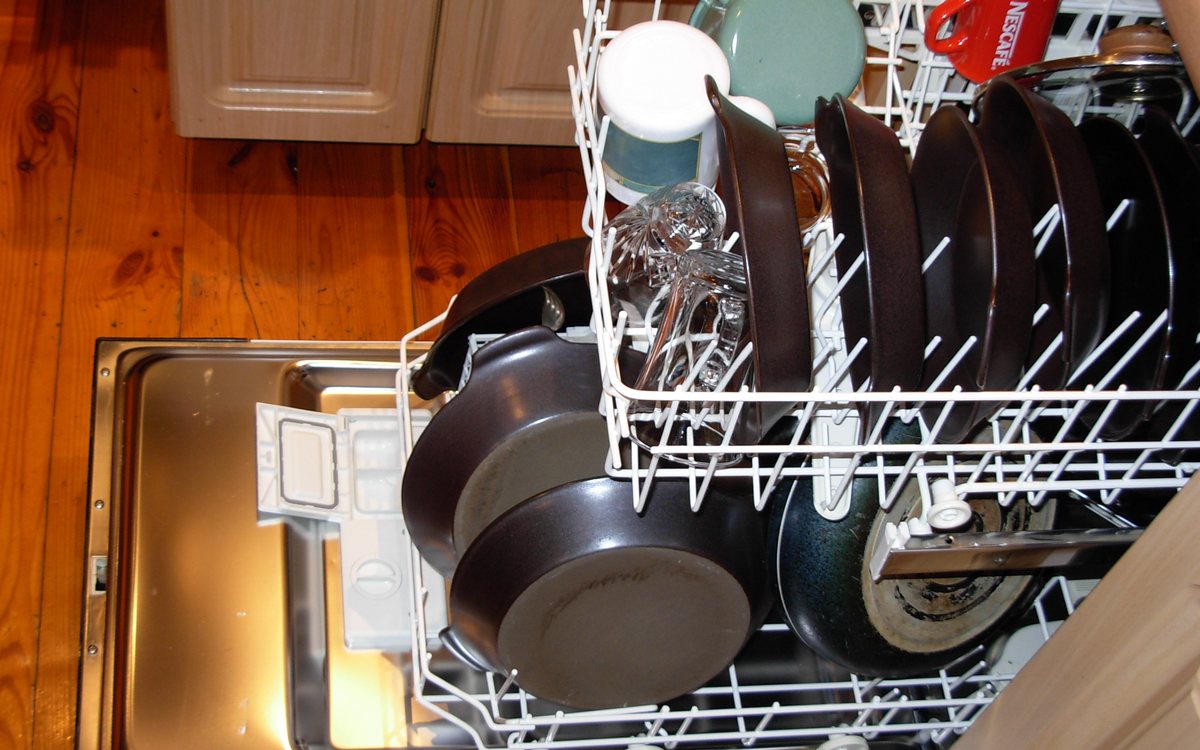 Open dishwasher interior with stainless racking, of the kind we repair in Walnut Creek homes