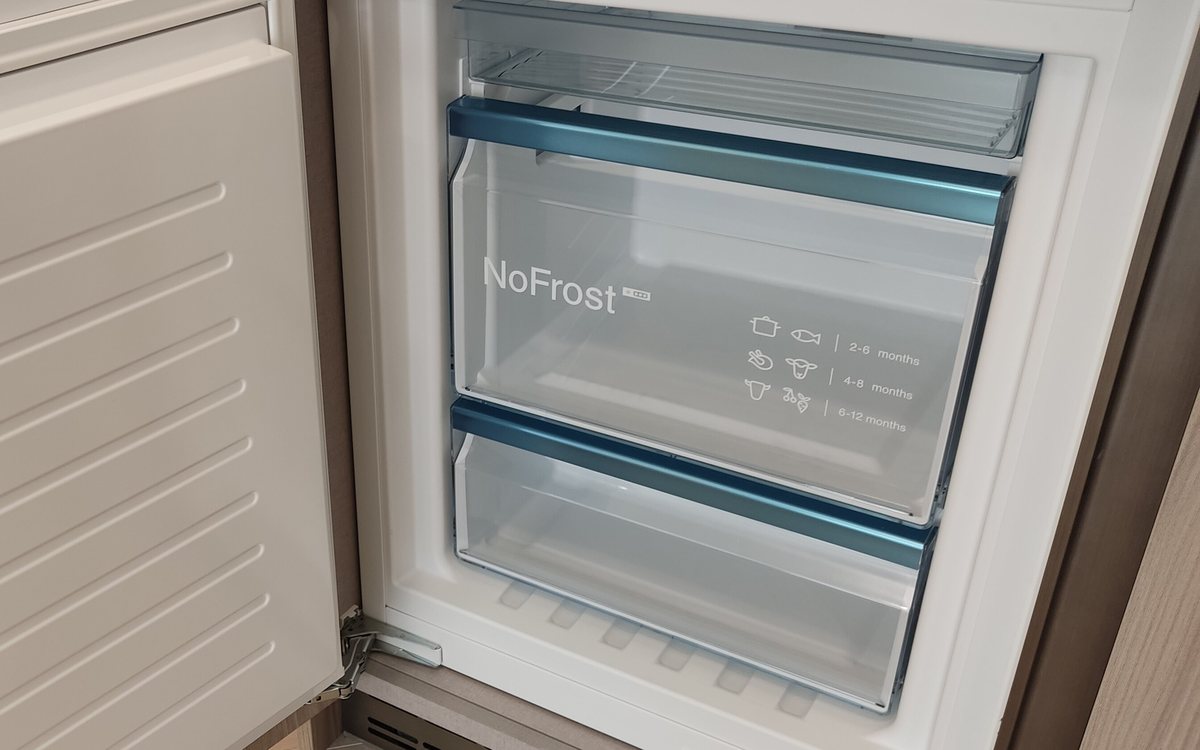 Open upright freezer with frosted shelves, of the kind we repair in Walnut Creek homes