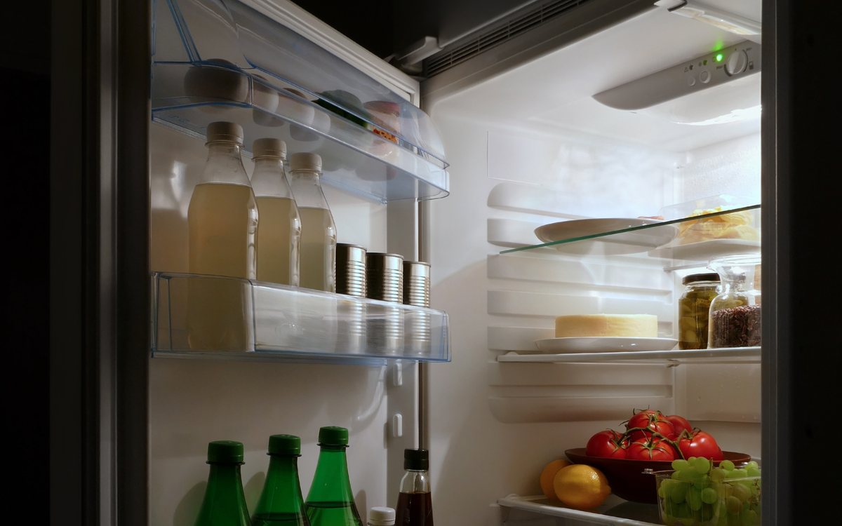 Open built-in refrigerator column with glass shelving, of the kind we repair in Walnut Creek homes