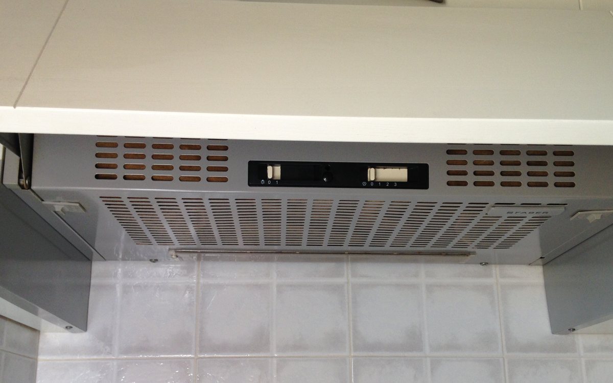 Stainless kitchen extractor hood mounted above a cooking surface, of the kind we repair in Walnut Creek homes